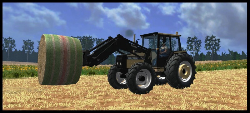 Valtra 715
Kun takakuormaimella ei enään ylettynyt piti hommata etukuormain raktori paaliajoon.
